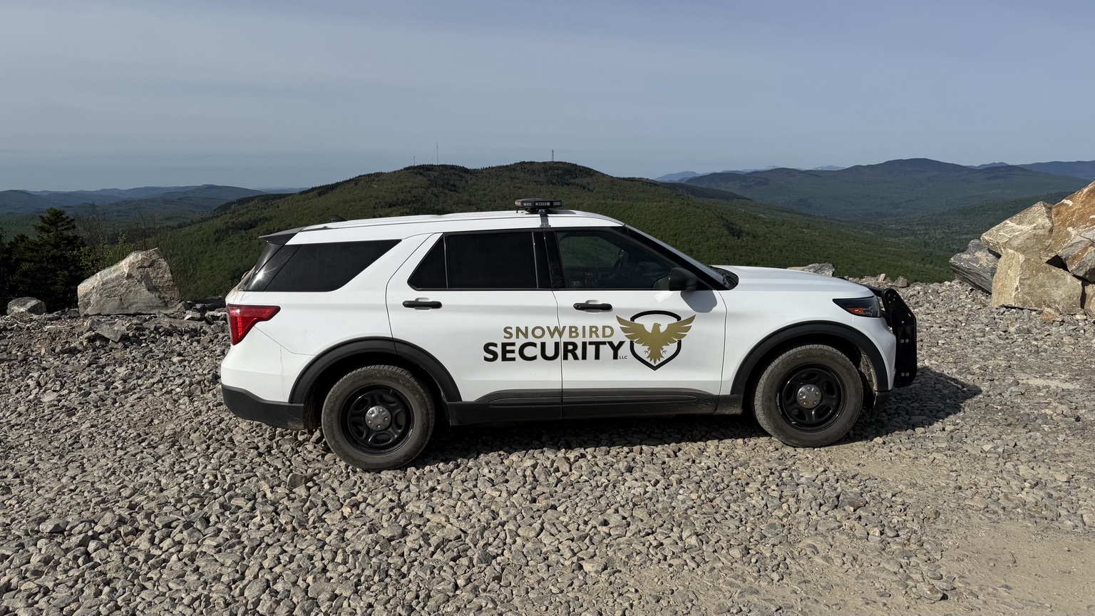 Snowbird Security patrol vehicle overlooking western Maine mountains